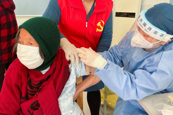 중국 상하이의 한 주민이 코로나19 백신을 맞는 모습. 〈사진=로이터·연합뉴스〉