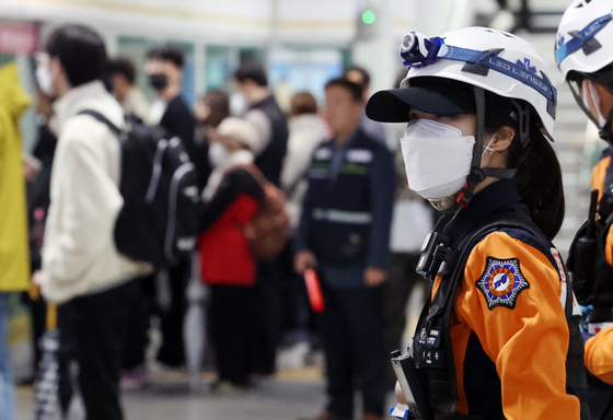 김포도시철도(김포골드라인)에 승객 과밀 현상이 이어진 18일 오전 경기도 김포시 고촌역 하행선 승강장에서 119구급대원들이 호흡곤란 환자 발생에 대비, 승객 과밀 상황을 지켜보고 있다. 〈사진=연합뉴스〉