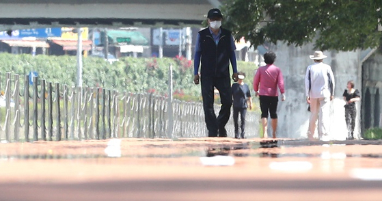 낮 최고기온이 32도를 넘긴 지난 17일 오후 대구 중구 대봉교 인근 신천둔치에서 시민들이 산책하는 모습. 〈사진=연합뉴스〉