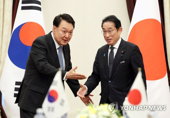 윤석열 대통령이 지난달 12일 리투아니아 빌뉴스 한 호텔에서 열린 한일 정상회담에서 기시다 후미오 일본 총리와 악수한 뒤 자리를 안내하고 있다. 〈사진=연합뉴스〉